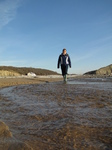 SX17199 Jenni walking through stream on Llantwit Major beach.jpg